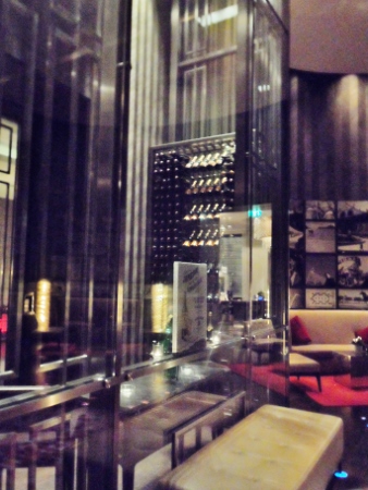 a glass wall with a wine rack in the middle