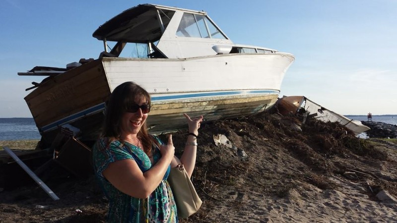a woman pointing at a boat