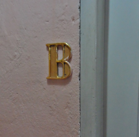 a gold letter on a wall