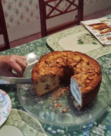 a person cutting a cake