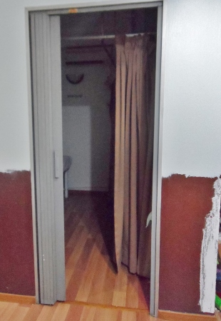a door with a curtain and a wood floor