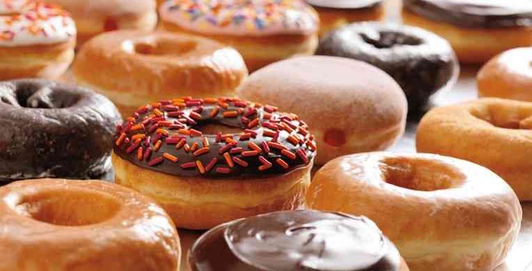 a group of donuts with chocolate frosting and sprinkles