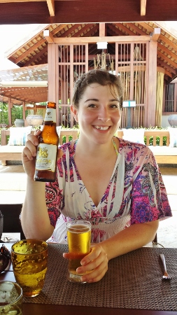 a woman holding a beer bottle