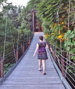 a woman walking on a bridge