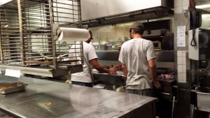 a couple of men working in a kitchen