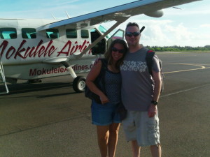 a man and woman standing in front of an airplane