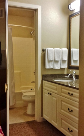 a bathroom with white cabinets and white towels