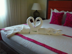 a towel swans made from towels on a bed