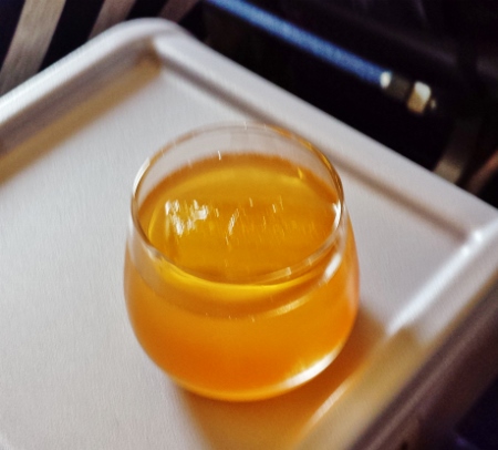 a glass of liquid on a tray