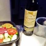 a salad and a bottle of wine
