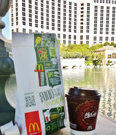 a fast food bag and coffee cup on a bridge