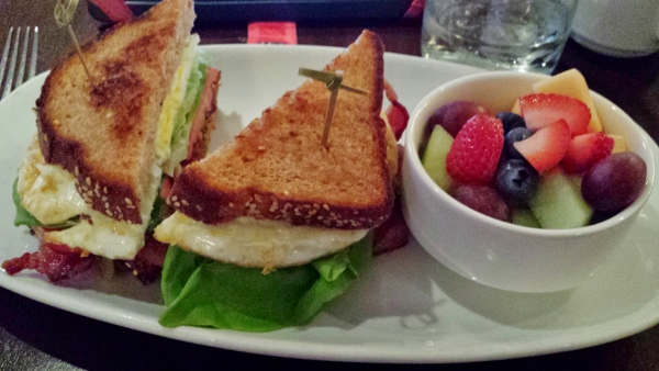 a plate of food with a sandwich and fruit