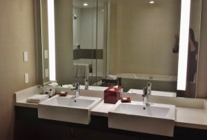 a bathroom with two sinks and a mirror