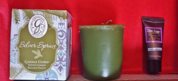 a green candle next to a box