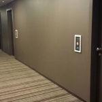 a hallway with a door and elevator