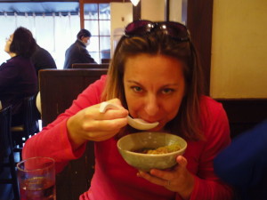 a woman eating a bowl of food