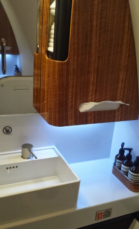 a bathroom with a sink and a wooden cabinet