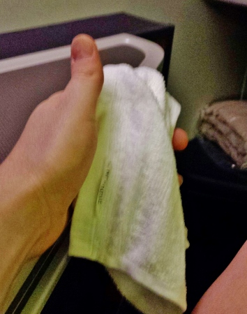 a hand holding a white towel