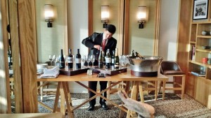 a man pouring wine into a table