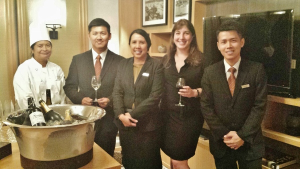 a group of people in suits holding wine glasses