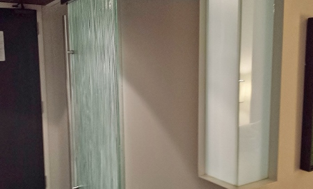 a glass wall next to a mirror