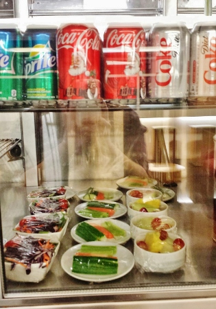 a display case with food and drinks