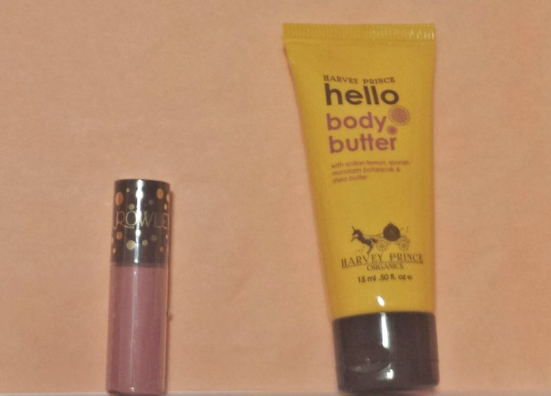 a tube of body butter next to a tube of lip gloss