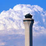 a tower with a large cloud in the background