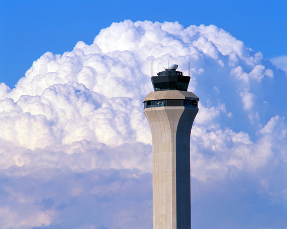 a tower with a large cloud in the background