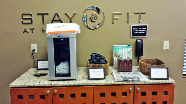 a hotel reception desk with a sign and a machine
