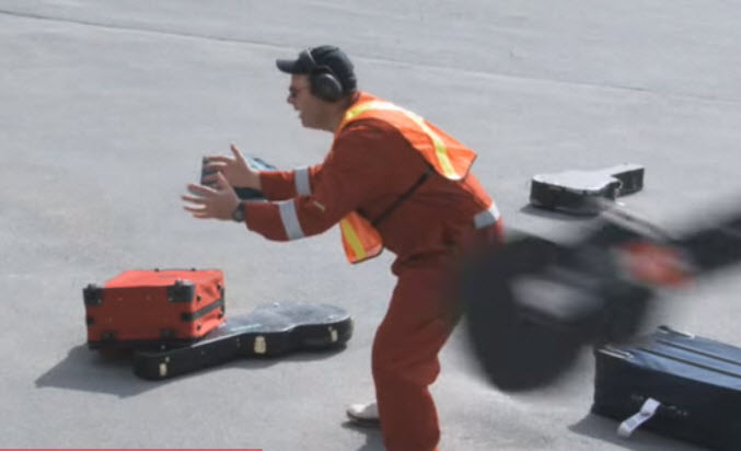 a man in orange jumpsuit and headphones with a case
