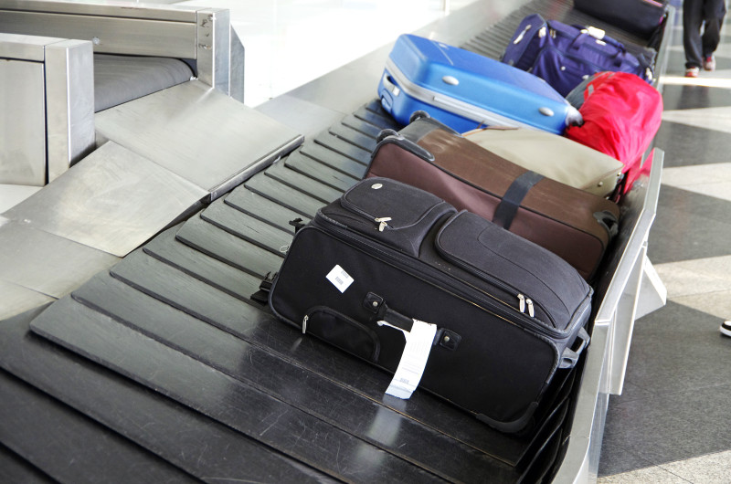 a group of luggage on a conveyor belt
