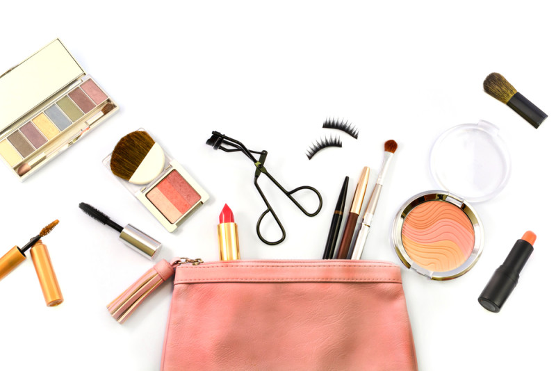 a pink bag with makeup products and tools