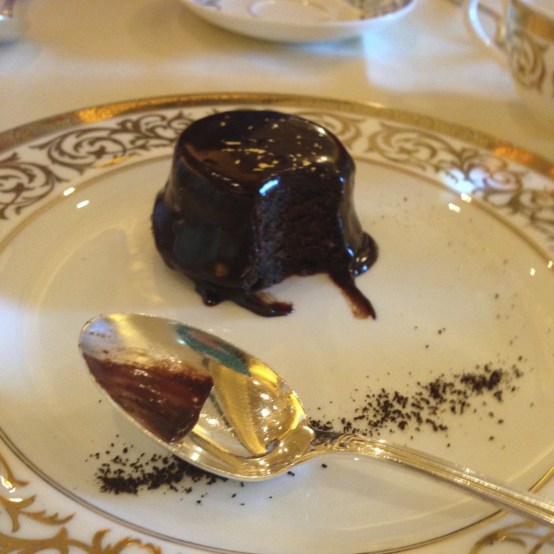 a chocolate cake on a plate with a spoon