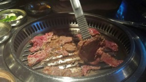 a meat being cooked on a grill