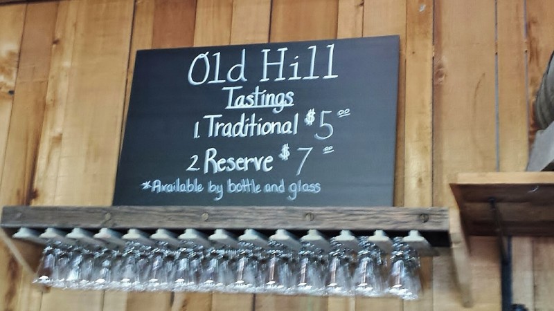 a sign with wine glasses from a rack