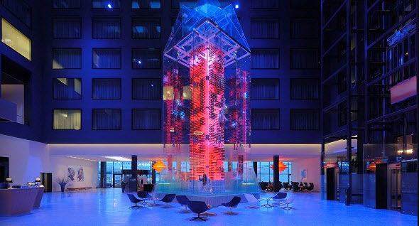 a glass tower with red lights