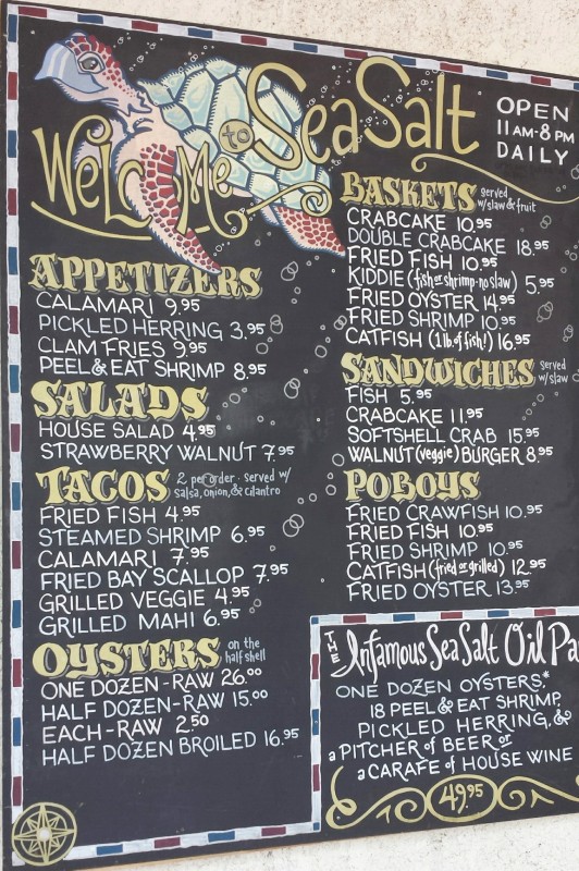 a menu board with a fish and seafood