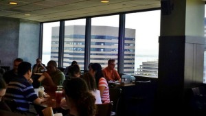 a group of people sitting at tables in a restaurant