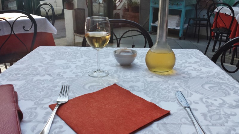 a table with a glass of wine and a fork on it