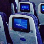 a row of seats with a television screen