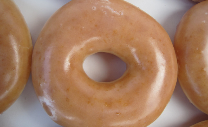 a glazed doughnut on a white surface