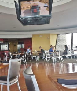 a tv from the ceiling in a restaurant