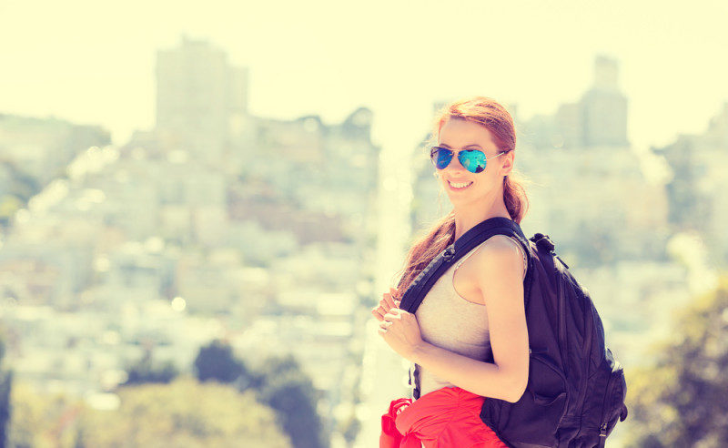 a woman wearing sunglasses and backpack