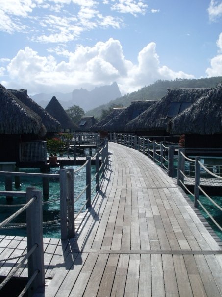 a wooden walkway leading to a resort