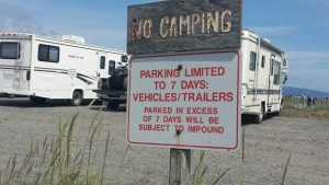 a no camping sign in front of a camper