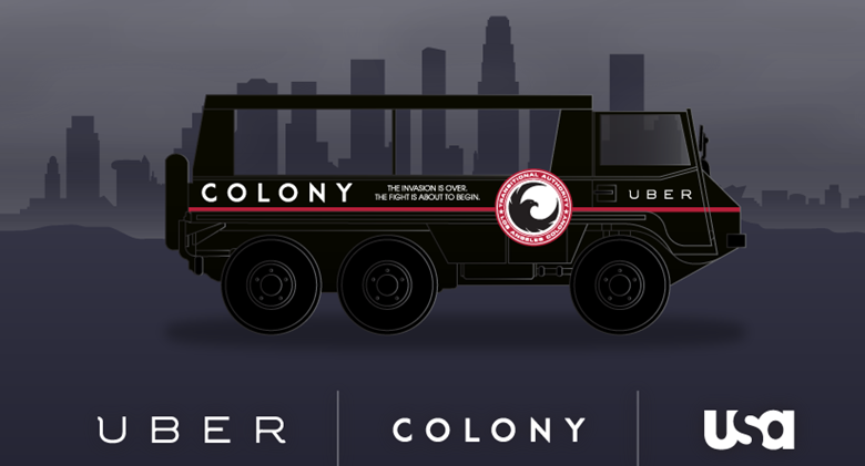 a black vehicle with a city behind it