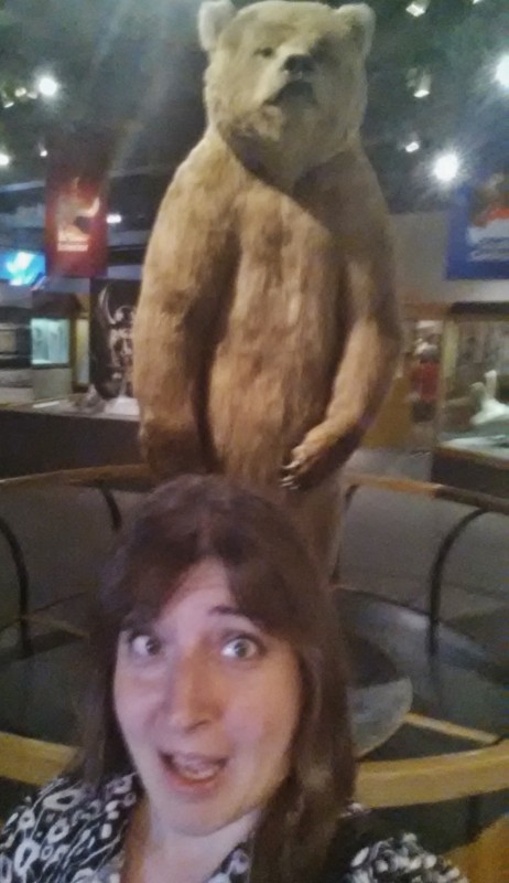 a woman taking a selfie with a stuffed animal