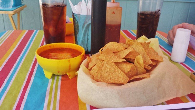 a bowl of chips and a bowl of salsa