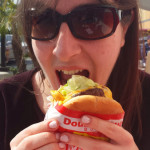 a woman eating a burger